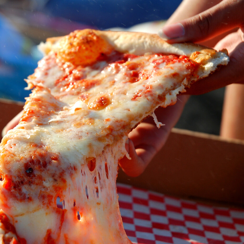 eating pizza on the beach